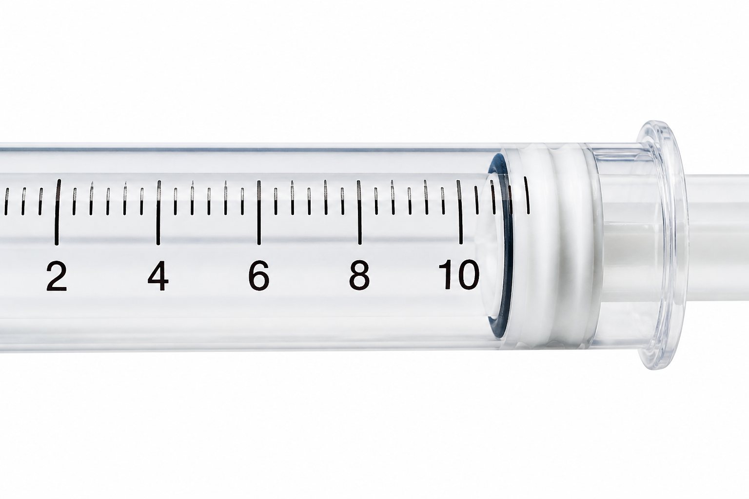 A clear syringe barrel in close-up, its black graduation marks and numerals running off the edge of the frame
